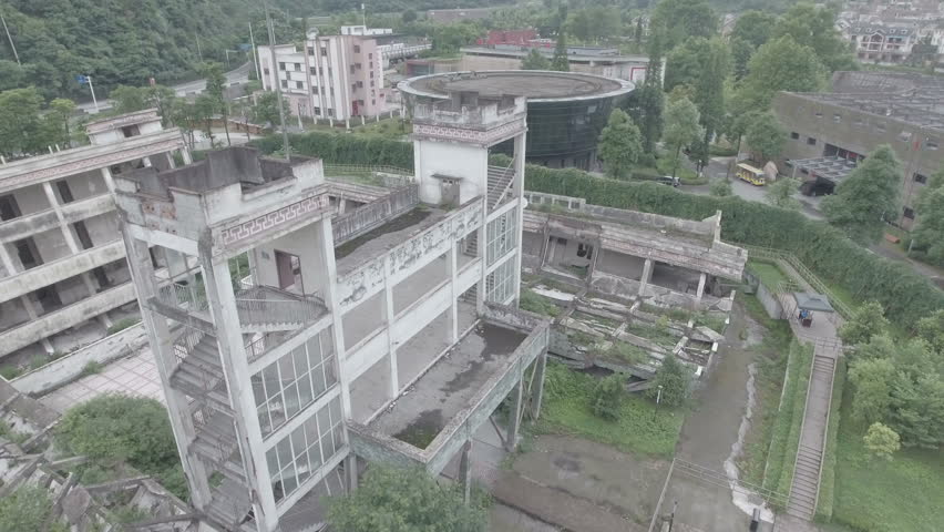 Flying backwards over a devastated school building, the remains of which form the Wenchuan earthquake memorial museum in Sichuan, China. D-log profile.