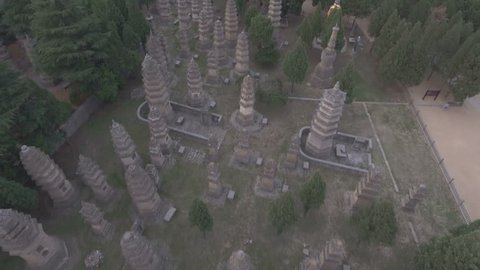Slow aerial flight over an pagoda forest, serving as a cemetery at the grounds of the Shaolin temple in Henan, China. 