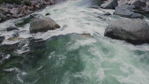 Drone Shot Flying Over Raging River in Mountain Forest
