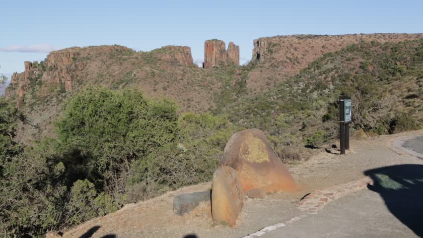 blur  in south africa valley of desolation dirty road rock tree and sky
