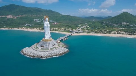 Flying towards a tall white Buddha statue on the tropical island Hainan, located in the South China Sea.