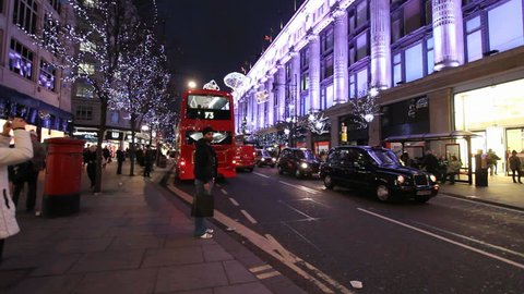 LONDON, UK - DECEMBER 27: Buses and other traffic drive past Christmas lights on Oxford Street on December 27, 2011 in London, UK. Oxford Street is one of the main shopping streets of London.