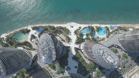 SANYA, CHINA - JULY 2016: Aerial view looking down on the modern Phoenix hotel resort complex on Hainan island in the South China Sea. Rooftops, swimming pools, palm trees. 