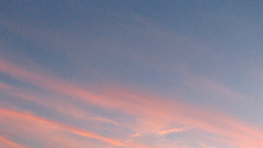 Sunset time lapse sequence of slowly vanishing purple clouds