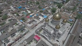 Aerial panning video of a small community mosque on the outskirts of Linxia, an important city for the Hui people (the main Muslim minority in China). 