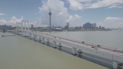 MACAU - JULY 2016: Aerial view of a long cable-stayed bridge connecting Macau peninsula (the iconic tower and casinos are visible) with Taipa island. 