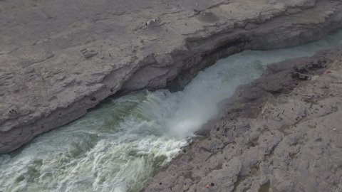 Rotating aerial footage of the Hukou waterfalls, part of the Yellow River in central China.