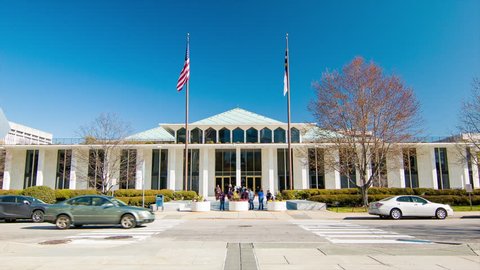 RALEIGH, NC - 2016: North Carolina State Legislative Building in Downtown Raleigh NC with People Visiting and Cars Driving Past on E Jones Street