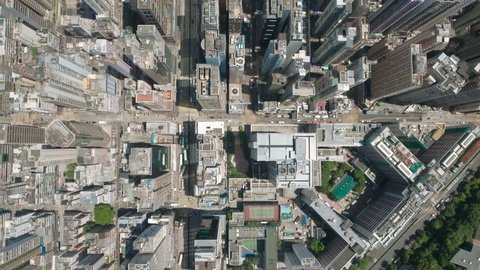 Abstract aerial drone footage of rooftops and streets in the densely populated Kowloon area in Hong Kong, one of Asia's most iconic modern cities.