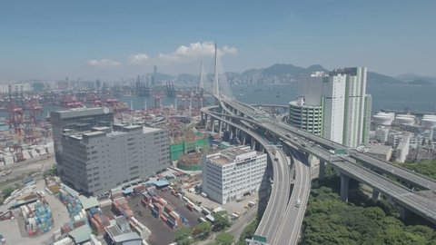 HONG KONG - JULY 2016: Aerial drone flight towards the impressive cable-stayed Stonecutters Bridge in Hong Kong, located to the cargo terminal and a major industrial zone. D-log profile DJI Phantom.