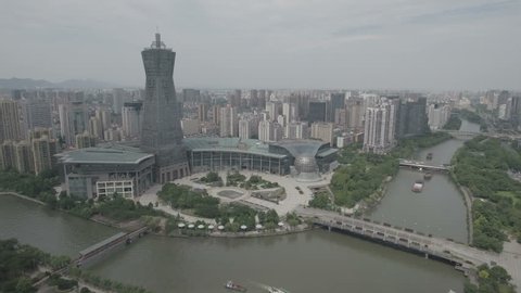 Aerial drone shot of a modern business and entertainment center, with residential apartment buildings in the background in the center of Hangzhou in Eastern China. D-log profile on DJI Phantom.
