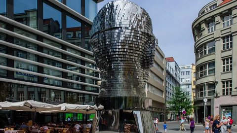 PRAGUE, CZECH REPUBLIC - AUG 25: People watching metal portrate of contemporary artist David Cerny with name Metalmorphosis on August 29 2016. 