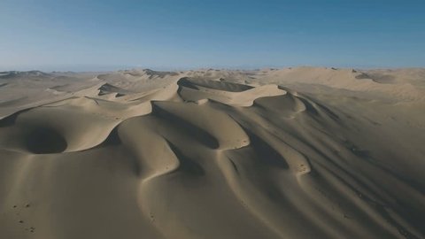Stark rugged desert landscape as seen from above. Beautiful looking sand dunes near the remote Dunhuang region in China. 