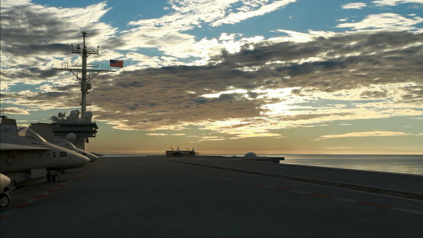 Two F18 Hornets taking off from an American aircraft carrier in the morning.