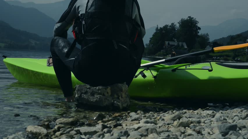 Kayaker Resting on the Shoreline Rock. Kayaking Sport.