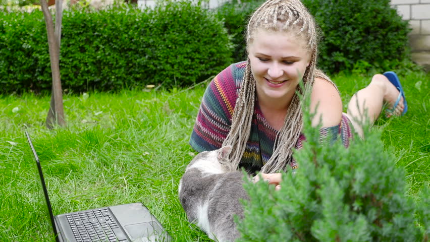 Girl plays with a cat on the nature. HD