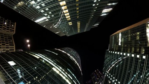 A group of modern skyscrapers in buisness night city, rotating timelapse