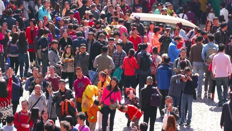 CHINA, MACAU - FEBRUARY 2016: Crowds Of People On Cobbled Street; R De Sao Paulo Macau China