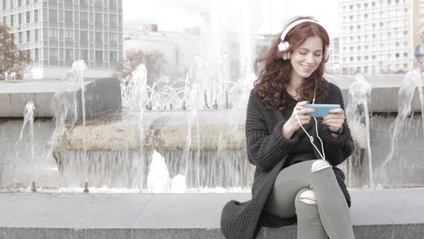 Girl listening music from smart phone mp3 player