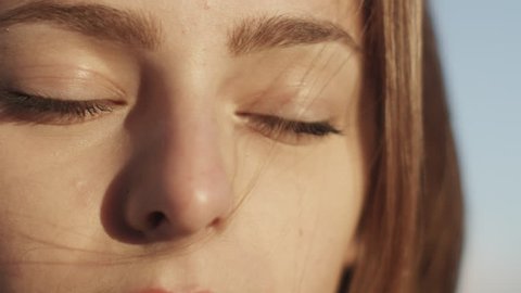 Portrait of Attractive Young Smiling Brunette Girl Opening Eyes and Looking Straight at Camera. Shot on RED Cinema Camera in 4K (UHD).