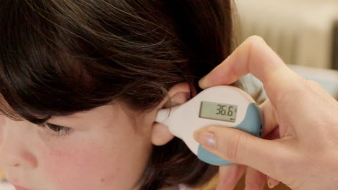 Child and digital thermometer
