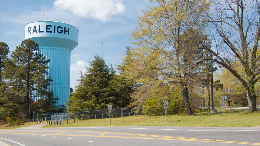 Raleigh North Carolina Water Tower with Passing Cars Street Traffic during Spring Season
