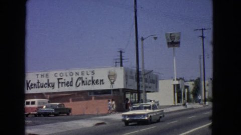 BARSTOW, CALIFORNIA 1966: the scene shows the early days of the world famous fried chicken food chain kfc cars pass by and the scene just perfectly shows from where it all started.