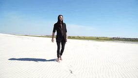 Walking barefoot on the sand in the desert