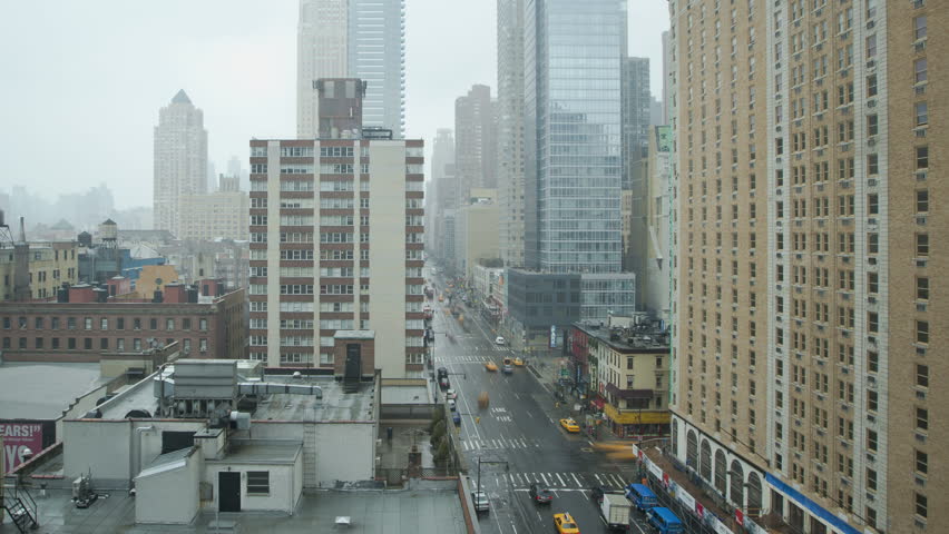 NEW YORK CITY - FEB 11: Timelapse of traffic on a wet street passing by on 8th