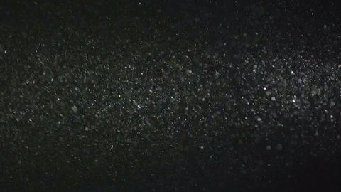 4 in 1 video! The particle of dust fly on the dark background. Slow motion