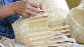 Woman weaving a basket of bamboo. Thailand handicraft. 