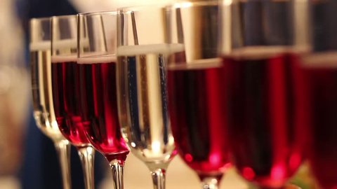 Glasses with alcohol and different drinks, glasses of wine and champagne are on the buffet table,red wine in glasses, champagne by the glass, buffet table with alcohol in a restaurant, side view,