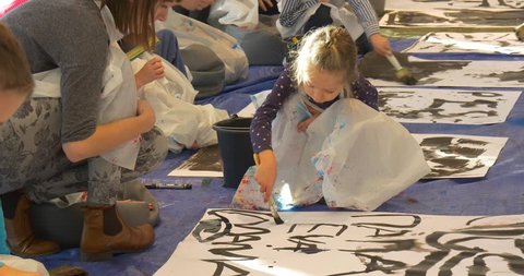 Families, Mums With Kids Paint Together at Master Class, Kids Are Painting Black, Writing on a Big Sheets of Paper. Family Master Class on Drawing and Painting in Opole, Gallery of Modern Art. People