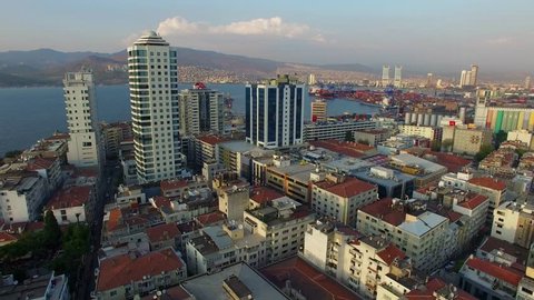 Izmir city center with coastline, ferries and fair. Turkish city, drone shot
