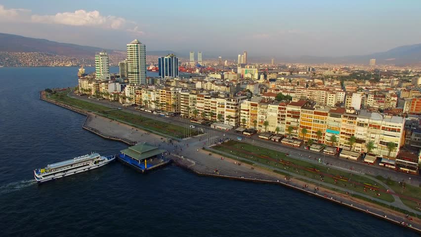 Izmir city center with coastline, ferries and fair. Turkish city, drone shot