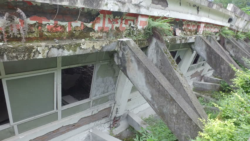Walking past collapsed buildings of a school at the Wenchuan earthquake memorial in Sichuan province, China
