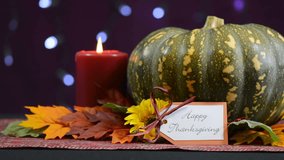 Happy Thanksgiving pumpkin centerpiece with candles against a bokeh fairy lights background, pan right.  - Powered by Shutterstock - Get 15% off with code: PIKWIZARD15