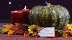 Happy Thanksgiving pumpkin centerpiece with candles against a bokeh fairy lights background, close up static.  - Powered by Shutterstock - Get 15% off with code: PIKWIZARD15