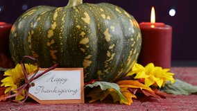 Happy Thanksgiving pumpkin centerpiece with candles against a bokeh fairy lights background, close up side zoom.  - Powered by Shutterstock - Get 15% off with code: PIKWIZARD15