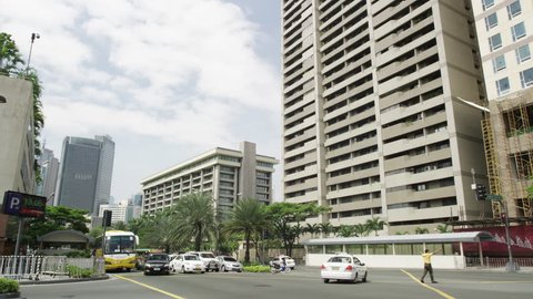 MANILA, PHILIPPINES - MARCH 9, 2013: Street Scene Ayala Avenue with Afternoon Traffic and Modern Apartments, Makati