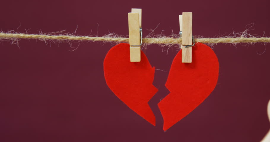 Conceptual image of figurine in front of broken heart 4k