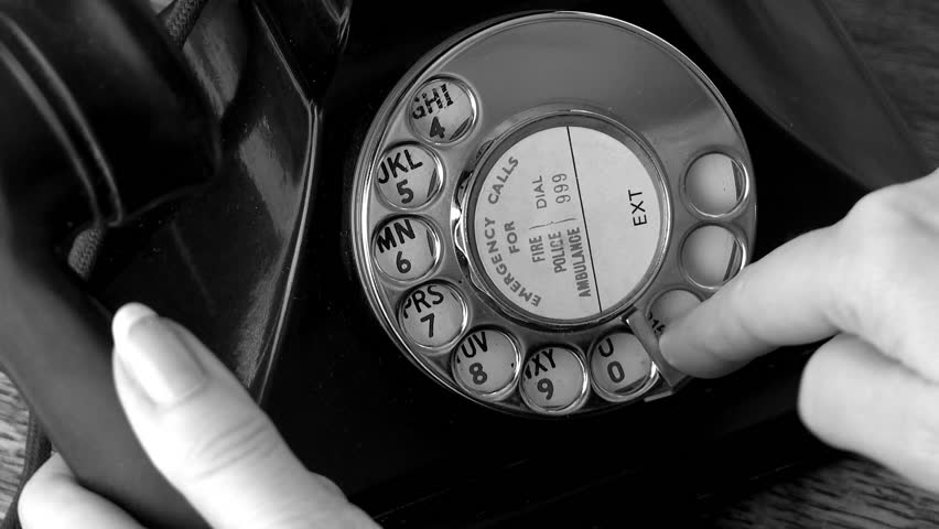 Dialing antique telephone in black and white
