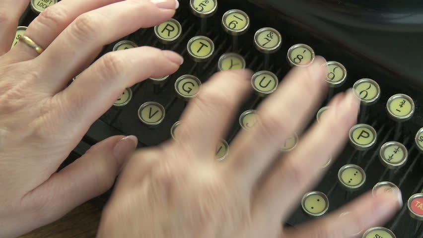 Woman typing on antique typewriter
