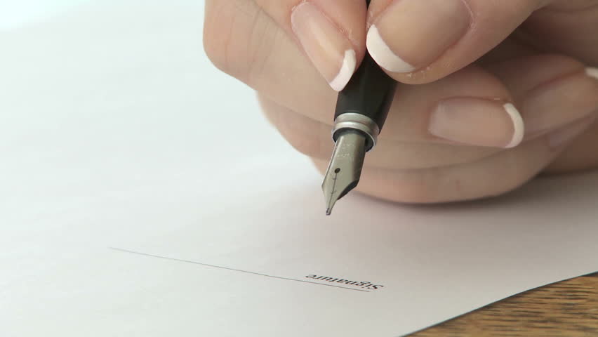Woman signing signature with a fountain pen