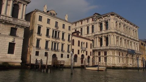 VENICE, ITALY - circa JULY, 2016: Venice Grand Canal attraction and palace, tourist pov view from waterbus sways on waves. Real time, 50fps