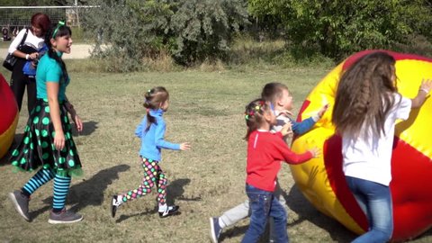 KHERSON, UKRAINE - SEPTEMBER 25, 2016: Children Play In Park With Zorb Bubbles Balls