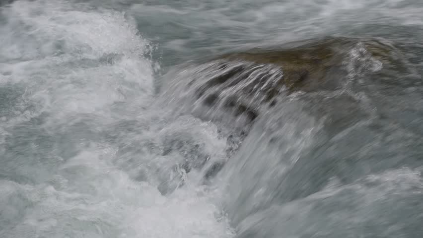The water of this crystal clear creek is flowing down many small romantic cascades on limestone rock-reefs