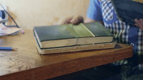 man reading old book close-up turns the page education video