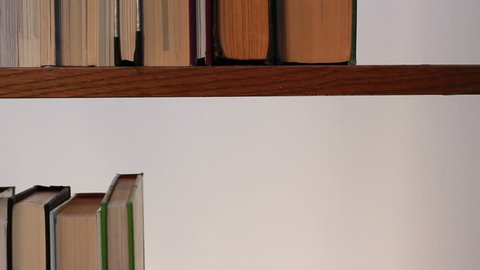 A closeup view of books placed on a shelf.