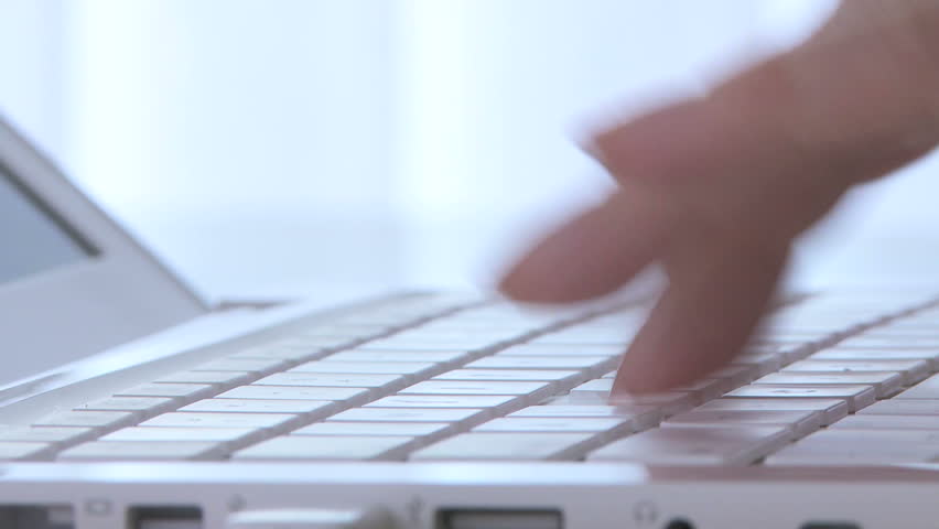Close up of woman's fingers typing on laptop keyboard